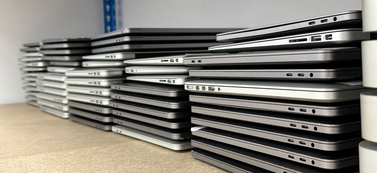 Stacks of retired business laptops at the SF IT Recovery facility